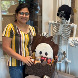 A BIG Congratulations to the winner of the Boo Basket! person posing with a gift basket