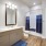Large well lit bathroom with white accents 