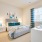 Large well lit bedroom with plush carpets and large windows 