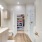 Large well lit bathroom with white accents 