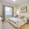 Large well lit bedroom with plush carpets and large windows 
