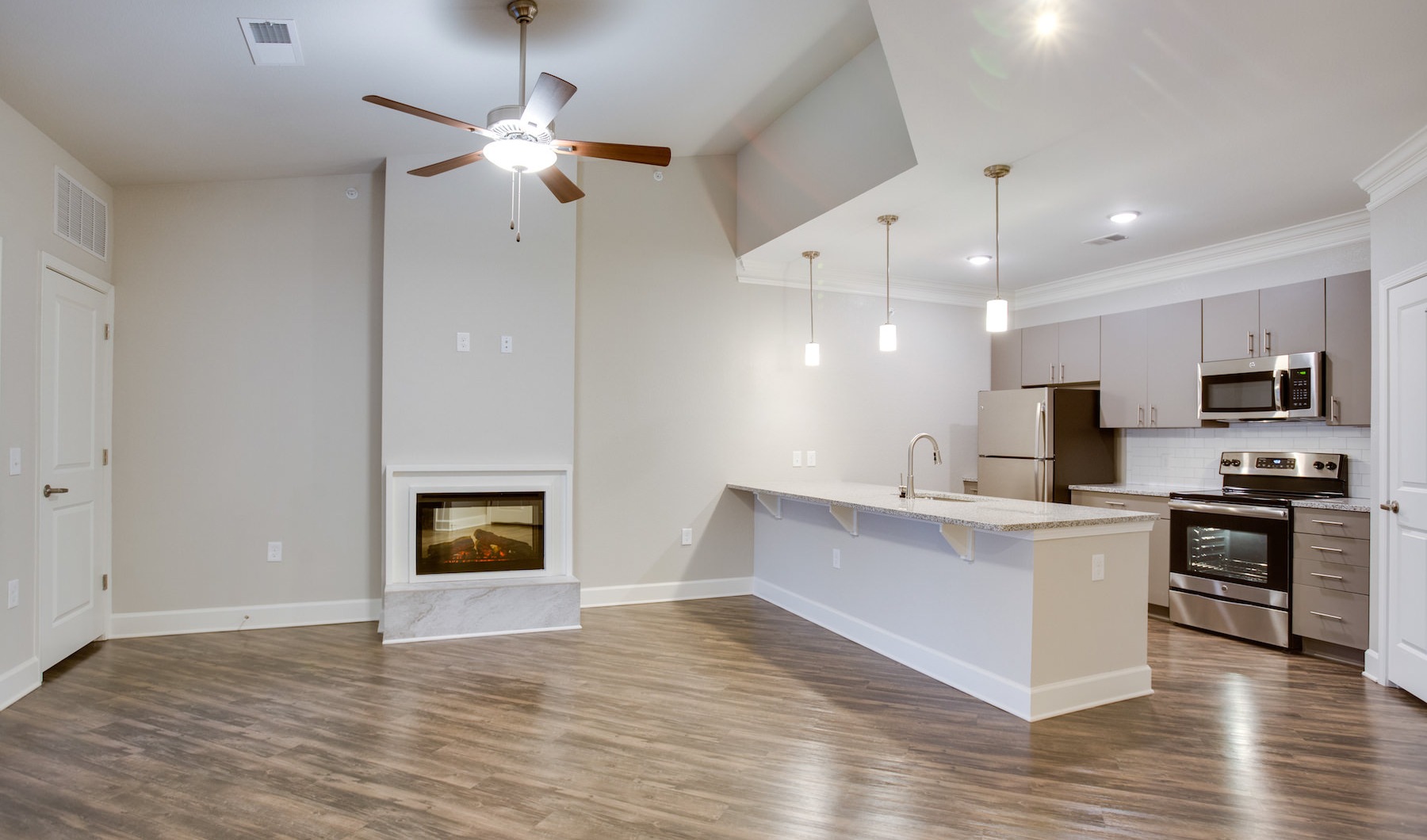 Kitchen Spacious and well lit kitchen with wood floors and stainless steel appliances